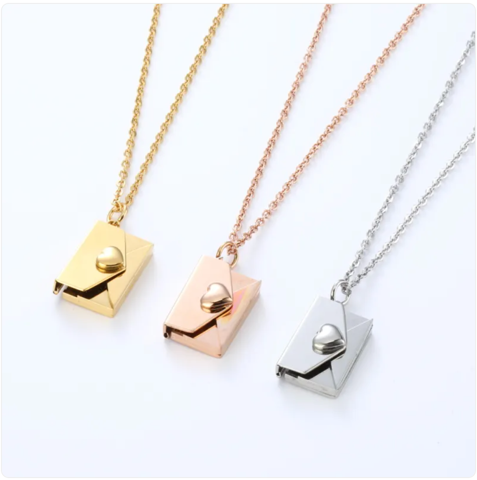 Envelope locket necklace in all three finishes: gold, rose gold and steel, on chains