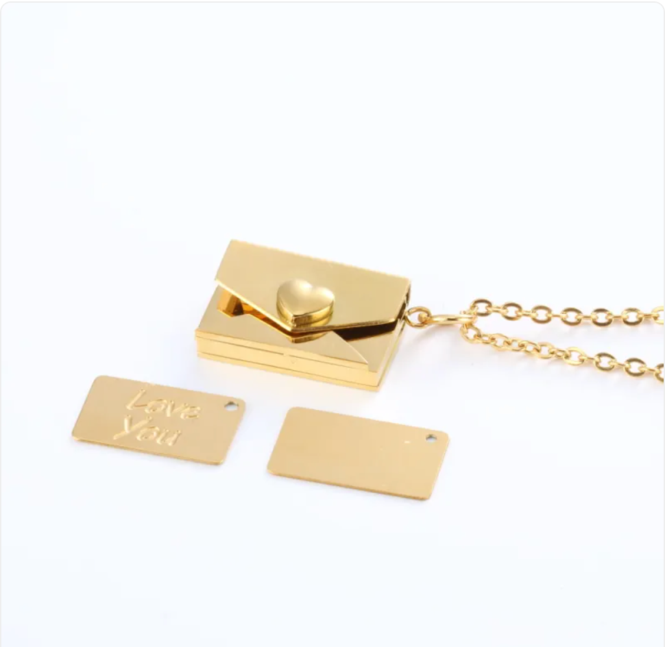Gold envelope locket necklace with heart clasp, shown with the Love You and blank message plates